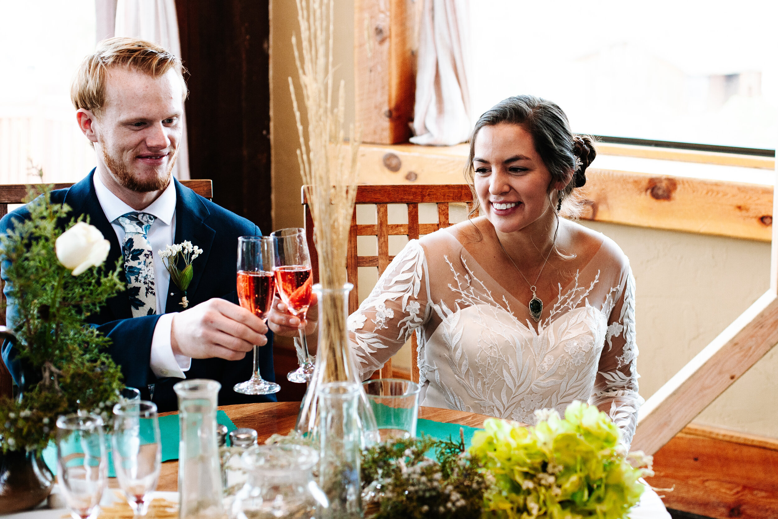 A couple at their wedding in Torrey, Utah toasting glasses of alcohol 