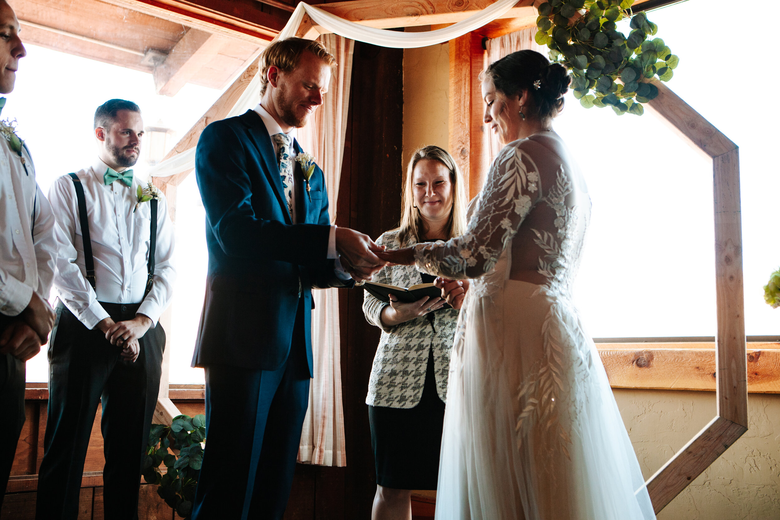 Couple exchanging their rings at their wedding ceremony near Moab, Utah.