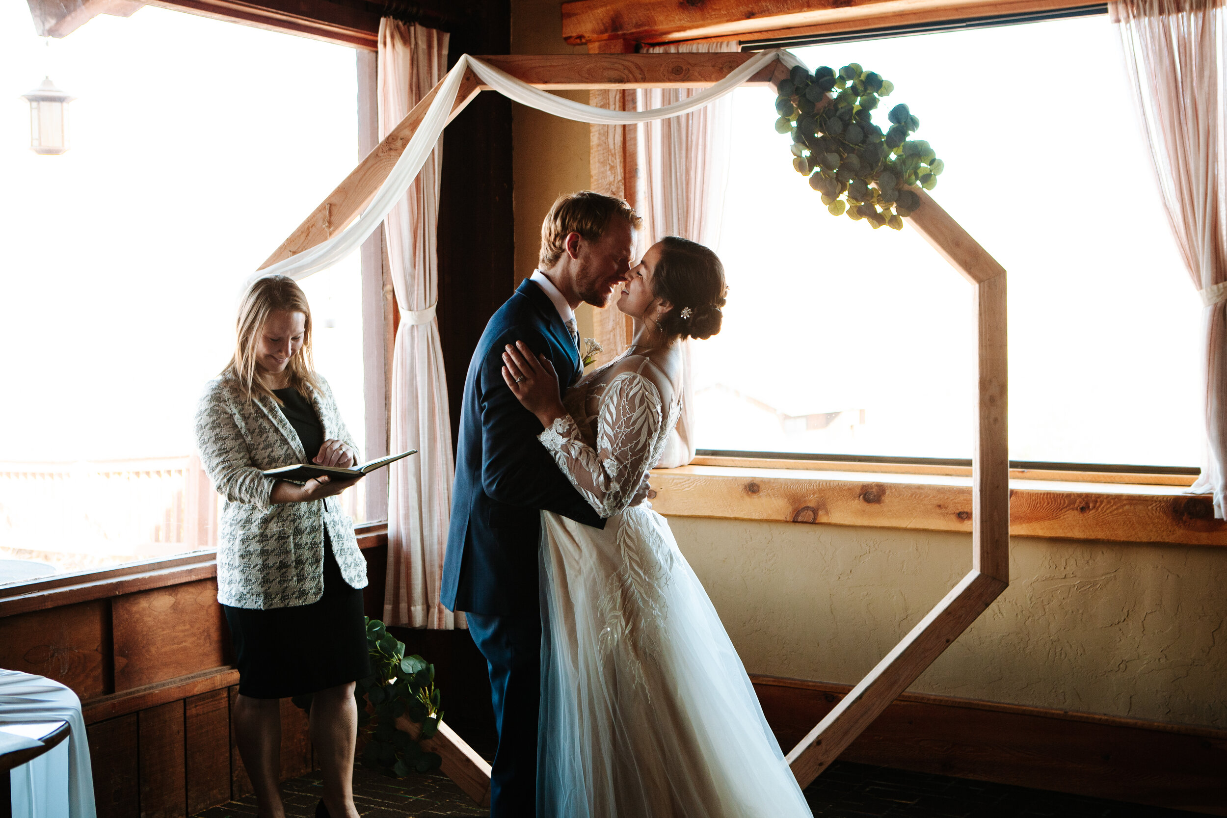 Couple having their first kiss at their wedding near Moab, Utah.