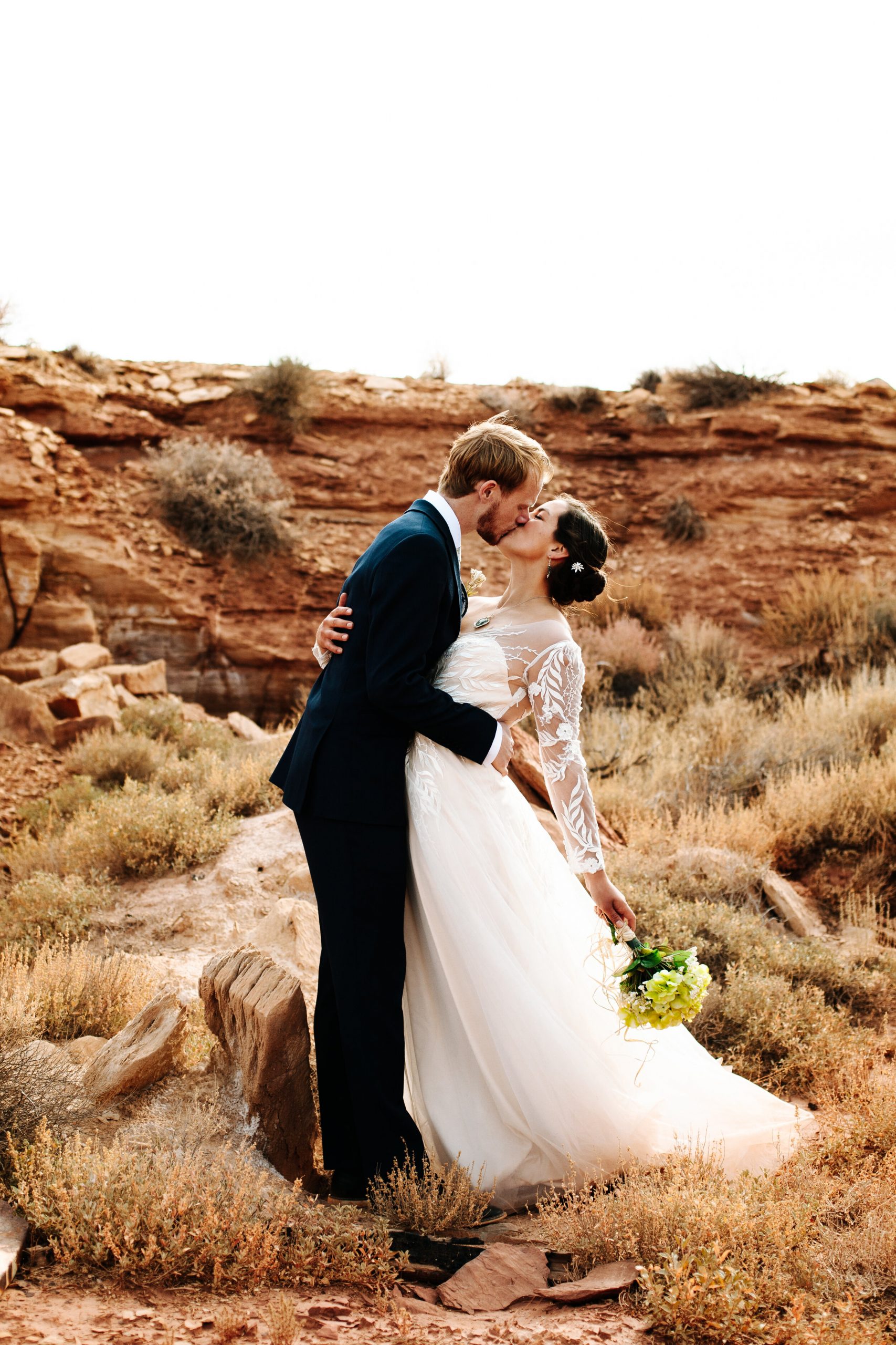 Couple kissing at their desert wedding in Moab, Utah.