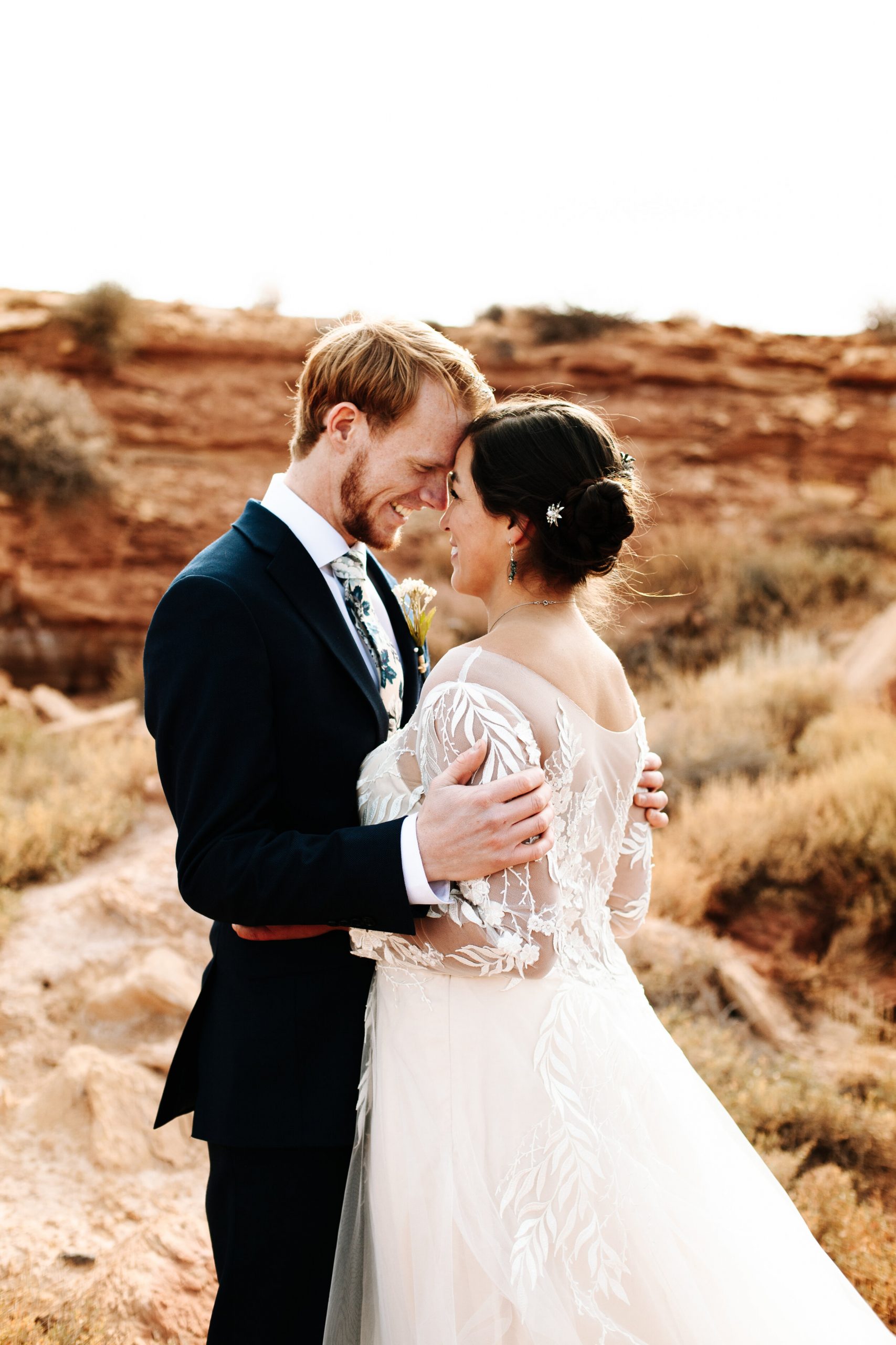 Couple looking at each other at their desert wedding in Moab, Utah.