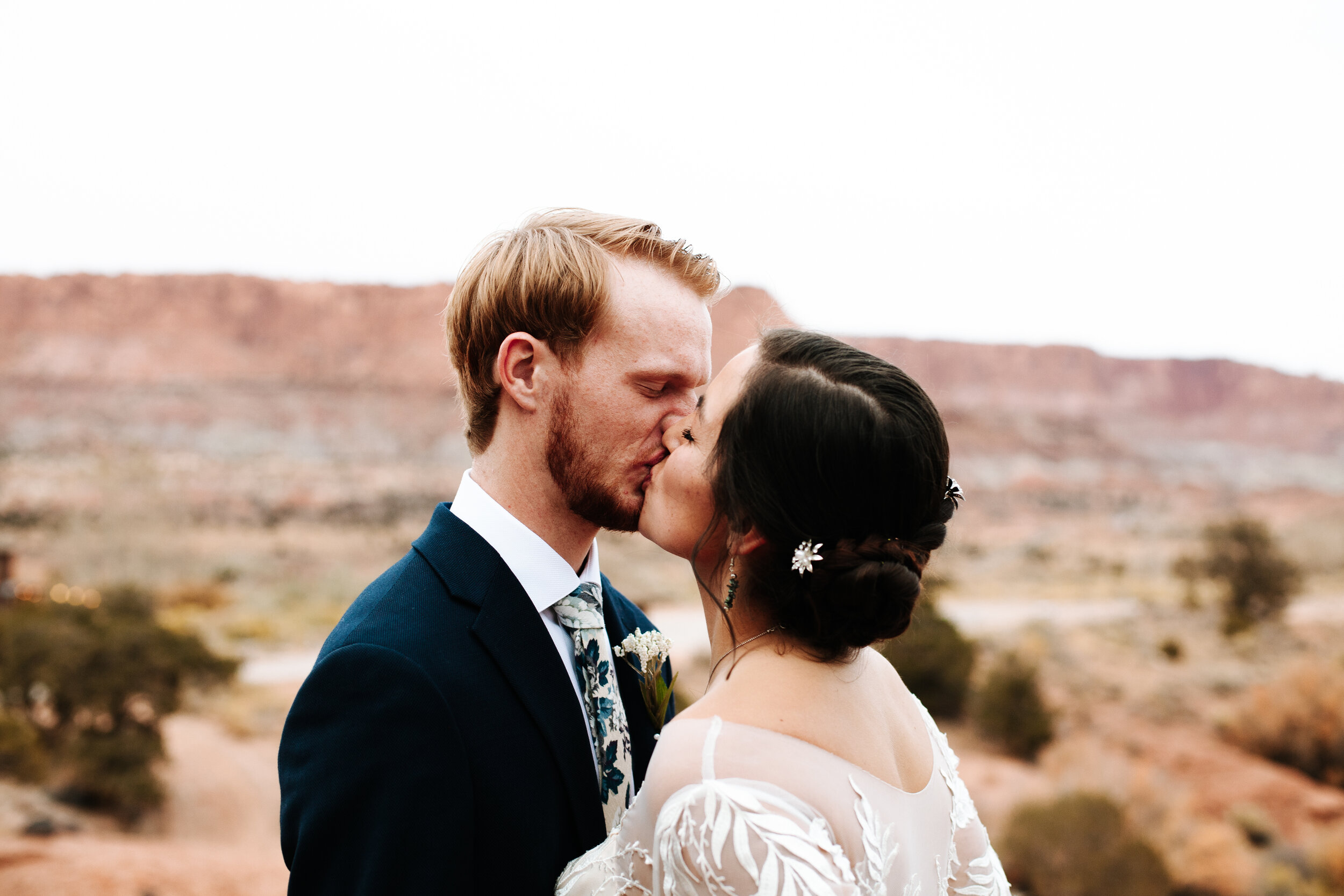 Couple kissing at their wedding in Moab, Utah.