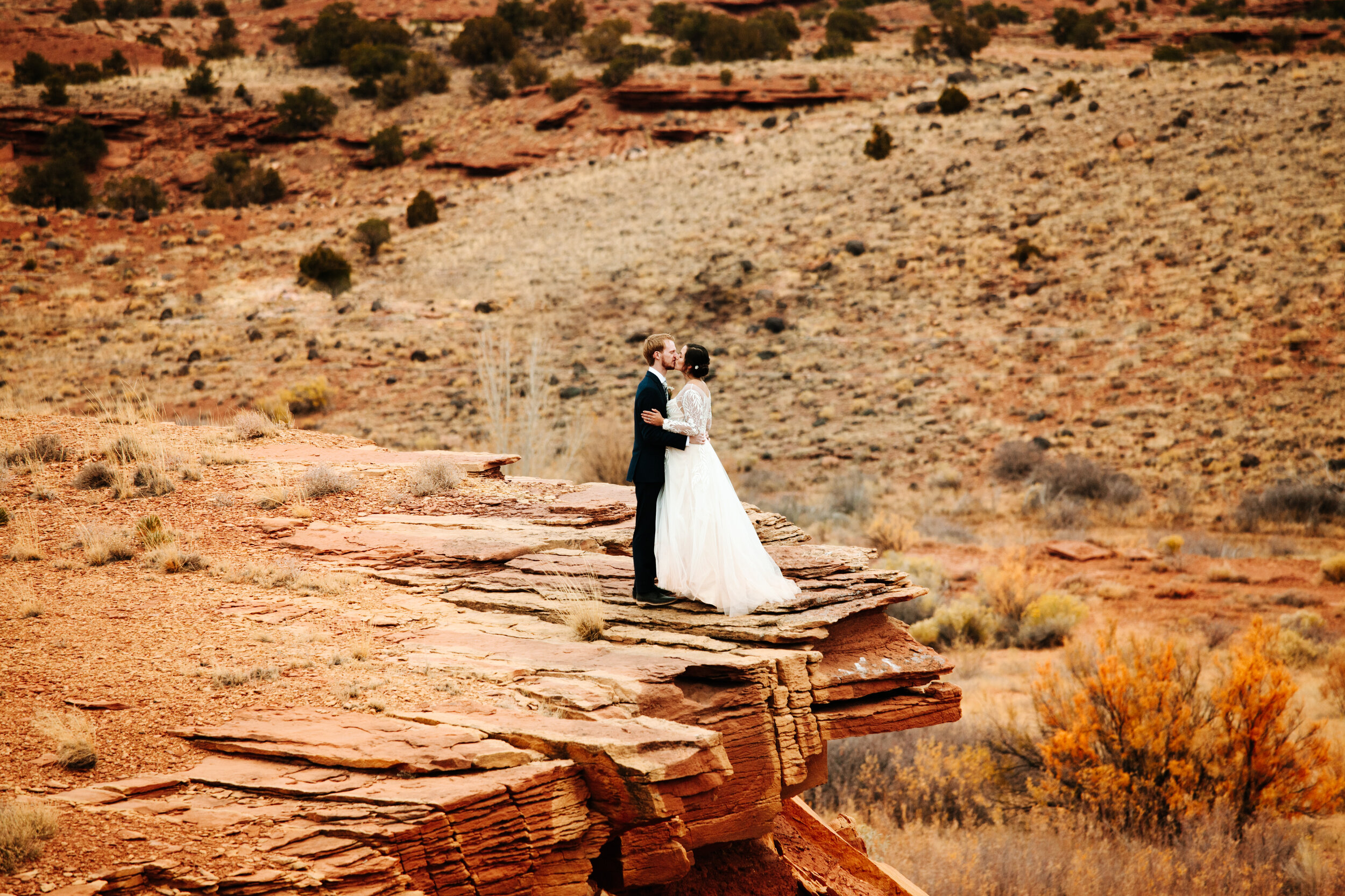 Couple kissing at their fall wedding in Moab, Utah.