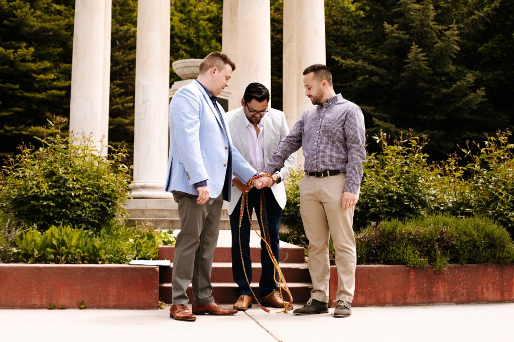 LGBTQ+ couple tying the knot at their wedding near the Utah State Capitol.