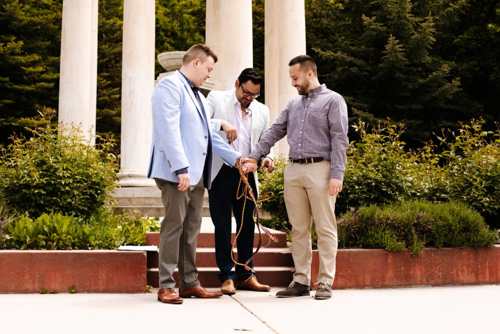 LGBTQ+ couple tying the knot at their wedding near the Utah State Capitol.
