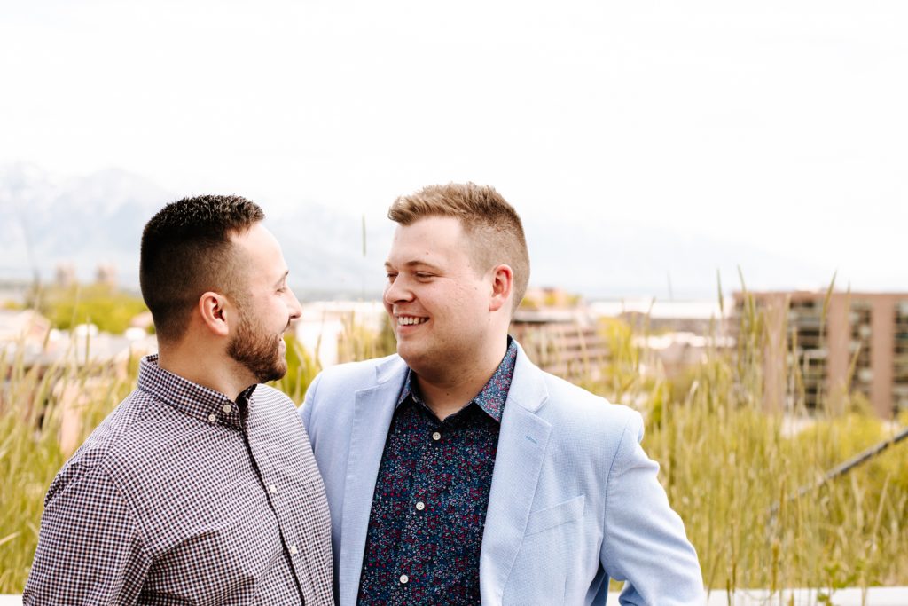 LGBTQ+ couple at their wedding near the Utah State Capitol. Utah mountains can be seen in the background.