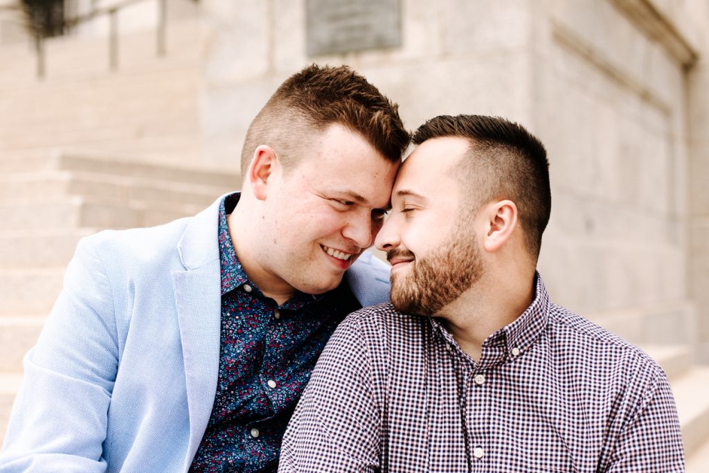 LGBTQ+ couple at their wedding in front of the Utah State Capitol.
