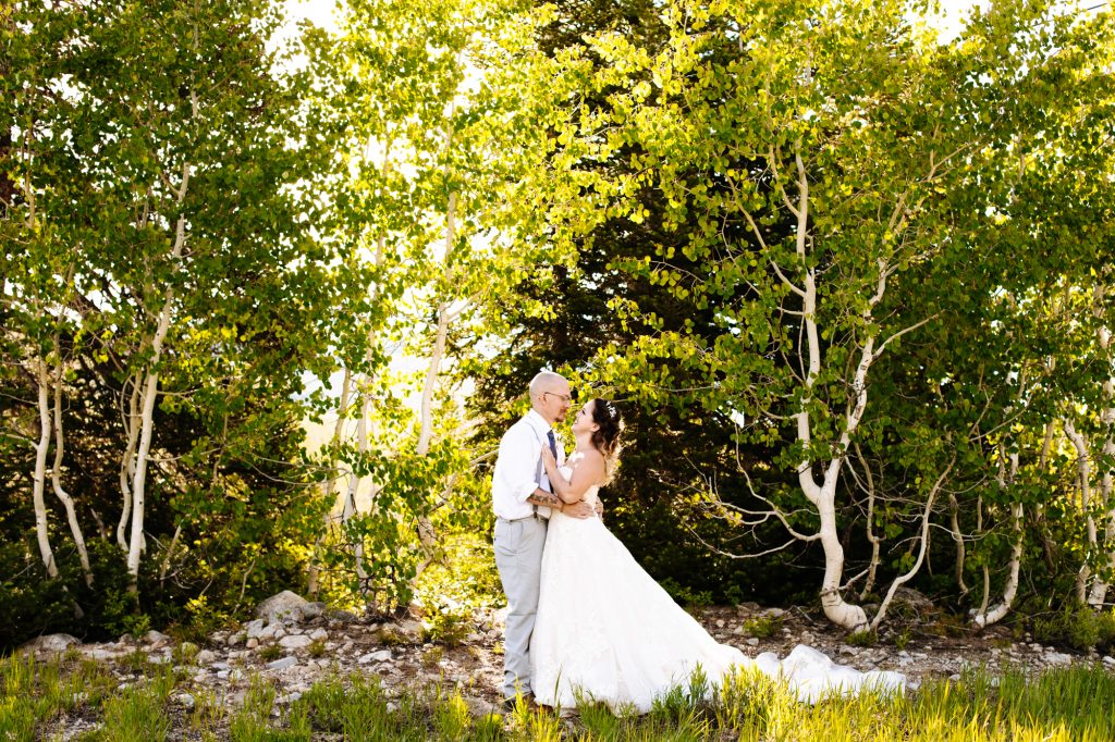 Bride and groom holding each other at their wedding in the mountain of Park City at Solitude Mountain Resort