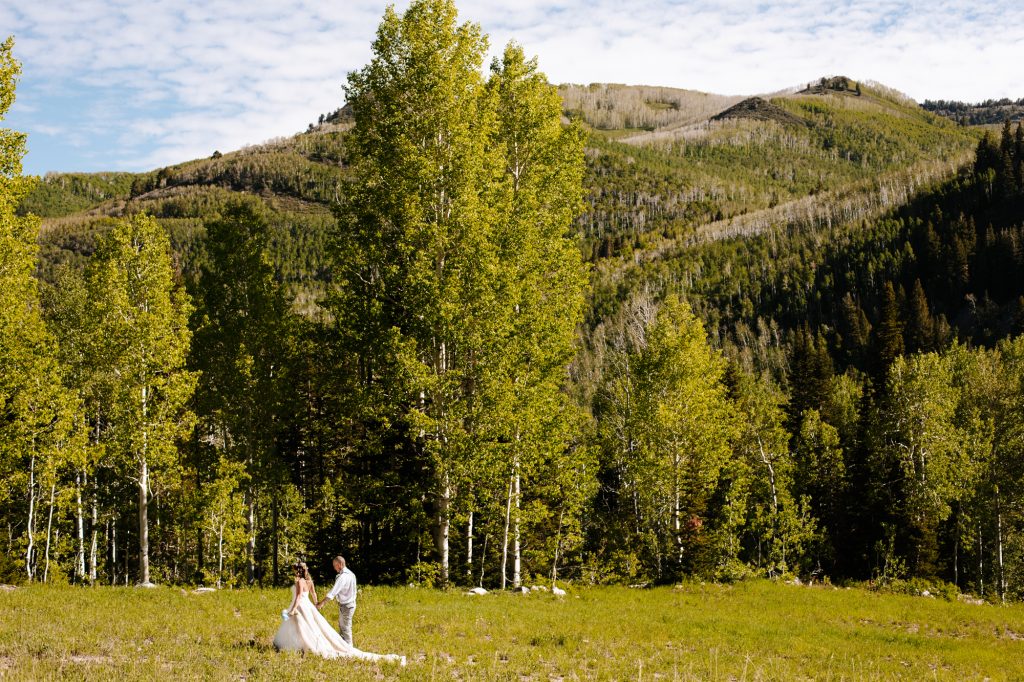 Bride and groom walking together at their wedding in the mountain of Park City at Solitude Mountain Resort