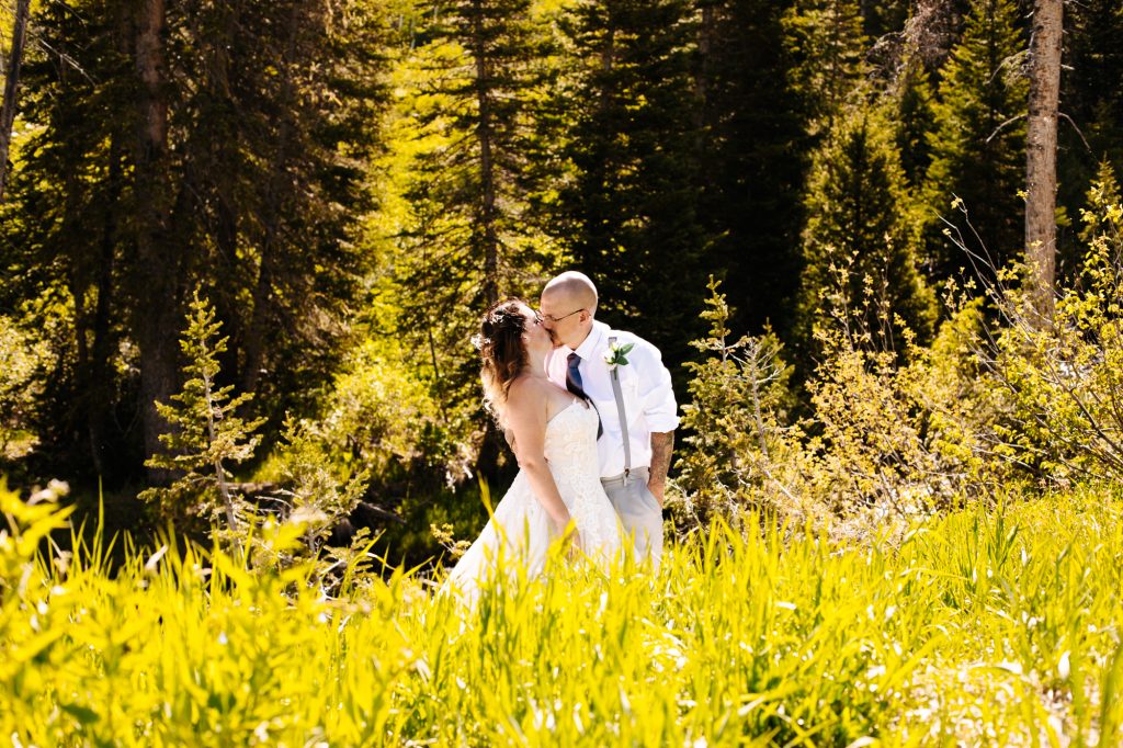 Bride and groom kissing at theri wedding in the mountain of Park City at Solitude Mountain Resort